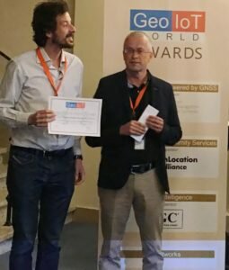 Matteo Faggin of GiPStech receiving the Indoor Positioning Award from ILA Vice-Chair Jouni Kamarainen at Geo-IoT World. 